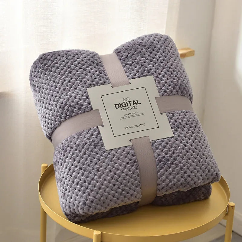 Gray waffle cut baby blanket swaddle for newborns folded neatly with packaging and soft texture