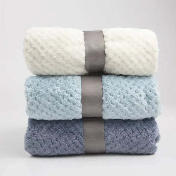 Set of three waffle cut baby blankets in white, light blue, and gray for newborn swaddling