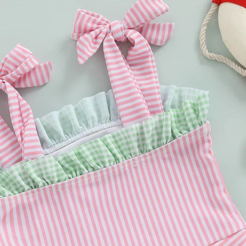 Pink and green striped watermelon baby swimsuit made of soft breathable fabric with bow shoulder straps