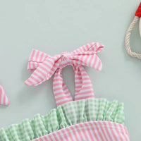 Close-up of pink and white striped tie strap with green gingham ruffle made of soft cotton in watermelon baby swimsuit
