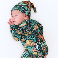 Sleeping newborn wearing The SoftKnot Cap in Wild West print, cozy bamboo headwear.