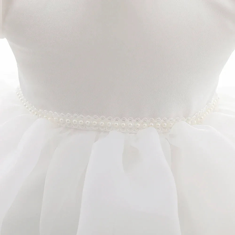 White baby girl tulle dress with pearl waist detail for infants and toddlers