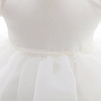 White baby girl tulle dress with pearl waist detail for infants and toddlers