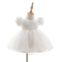 white baby girl tulle dress with puff sleeves and lace waist detail for infants