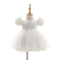 white baby girl tulle dress with puff sleeves and pearl waist detail for infants