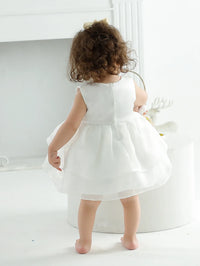 White baby occasion dress for toddlers with sleeveless design and full skirt detail