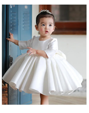 White special occasion dress for toddlers with long sleeves and full skirt