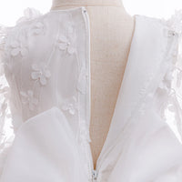 close-up of white flower girl dress with headband showing back zipper and delicate floral lace details