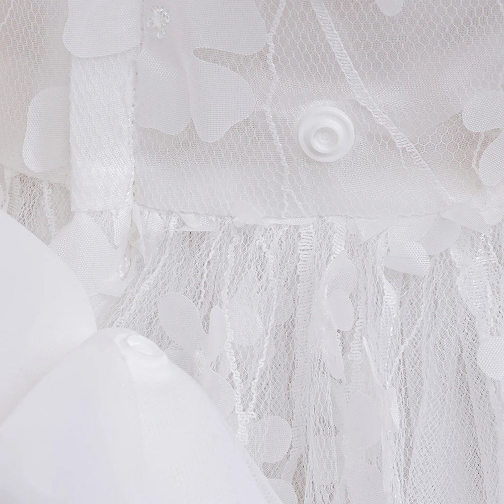 Close-up of white flower girl dress with headband showing floral lace and button details for baby