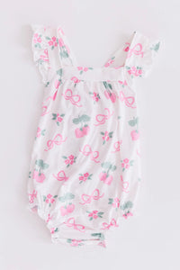 Mila & Rose ruffle cross back romper for little girls in white with pink bows and strawberry print