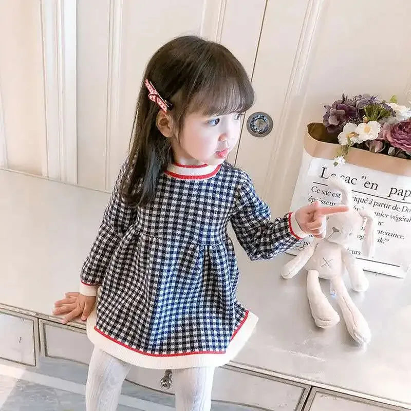 Black and white checkered winter knit dress for little girls with red trim on collar and hem, long sleeve toddler size