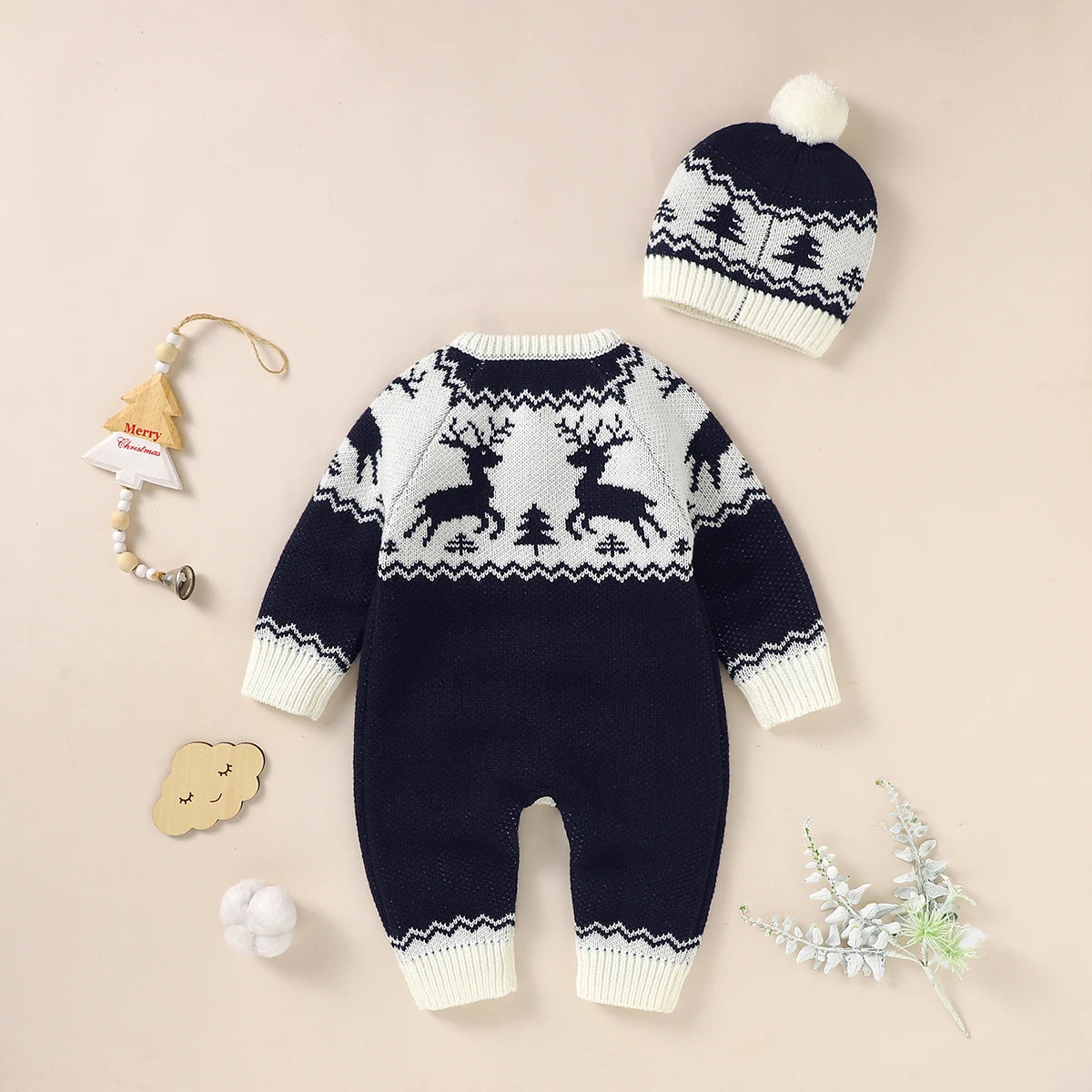 Navy and white winter knit rompers for babies with reindeer pattern and matching pom pom hat