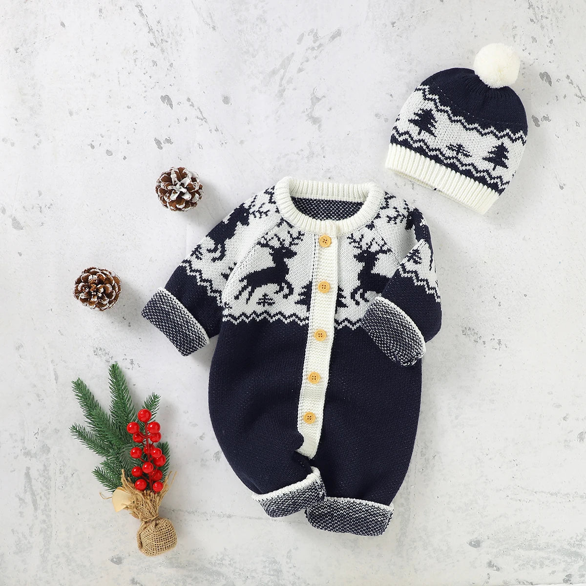 Navy and white winter knit rompers for babies with reindeer pattern and matching pom pom hat