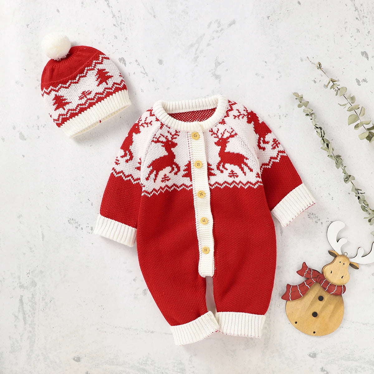 Red and white winter knit rompers for babies with reindeer pattern and matching pom pom hat