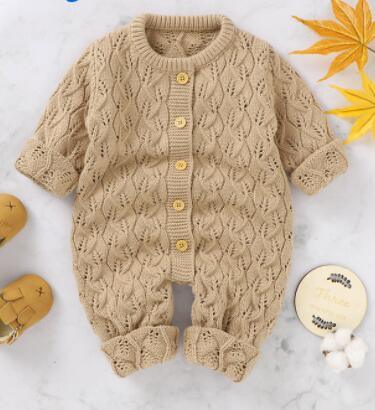 Beige knitted winter romper for babies with button closure and textured pattern