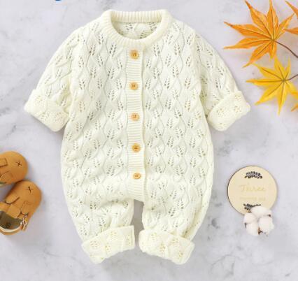 cream baby winter romper with knit leaf pattern and wooden buttons for infants