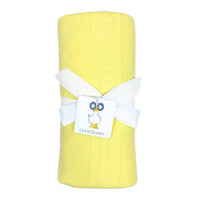 rolled yellow knit baby blanket for newborns with white ribbon and Goosewaddle tag