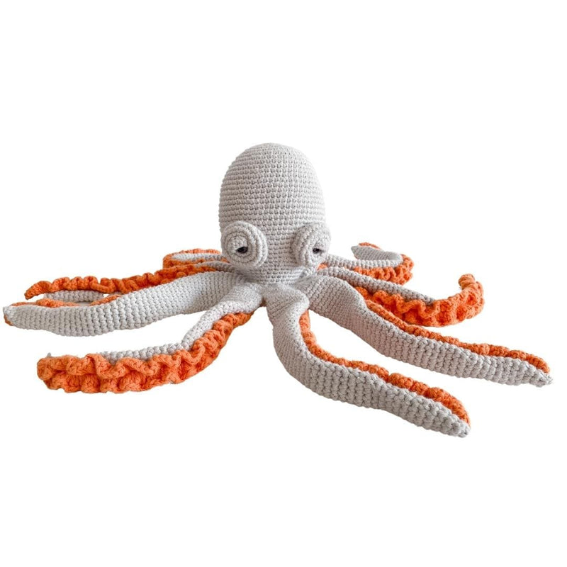 Grey crocheted octopus with eight curling arms and bright orange undersides. Soft organic cotton toy for children's rooms and nurseries.