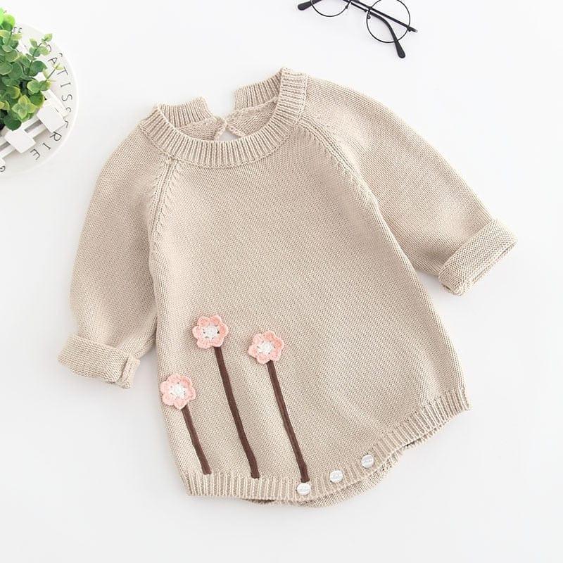 beige baby girl knit romper with long sleeves and pink flower applique for infants