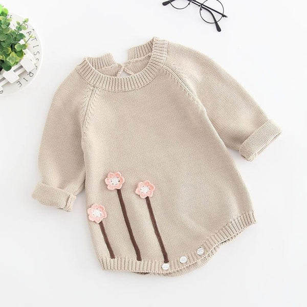 beige baby girl knit romper with long sleeves and pink flower applique for infants