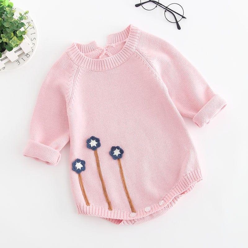 Pink baby girl knit romper for infants with long sleeves and blue flower embroidery detail