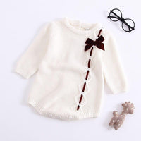 White baby girl knit romper with long sleeves and brown bow detail for infants