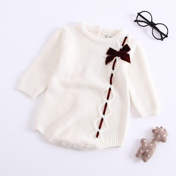 White baby girl knit romper with long sleeves and brown bow detail for infants