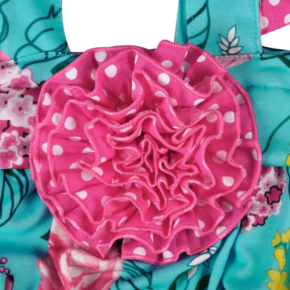 Boho baby summer outfit with turquoise floral pattern and pink polka dot ruffle detail for infants