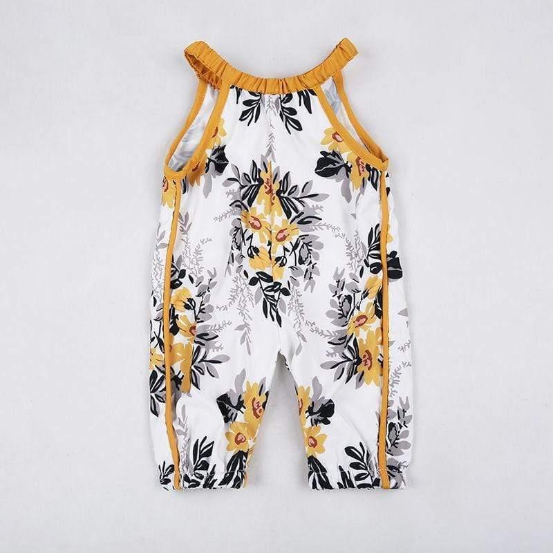 white and yellow boho floral baby romper with black leaf accents and mustard trim for infants
