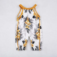 white and yellow boho floral baby romper with black leaf accents and mustard trim for infants