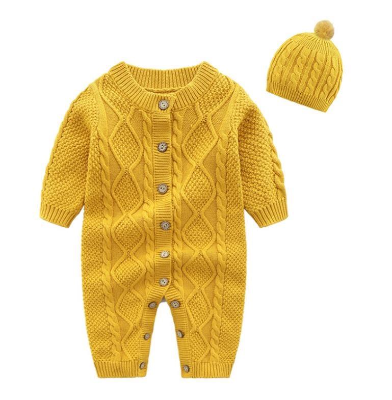 yellow knitted baby romper set for infants with cable knit pattern and matching pom pom hat