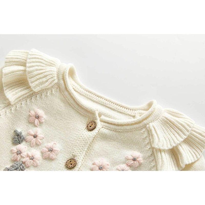 Cream crocheted floral baby romper set for infants with pink flower embroidery and ruffled sleeves