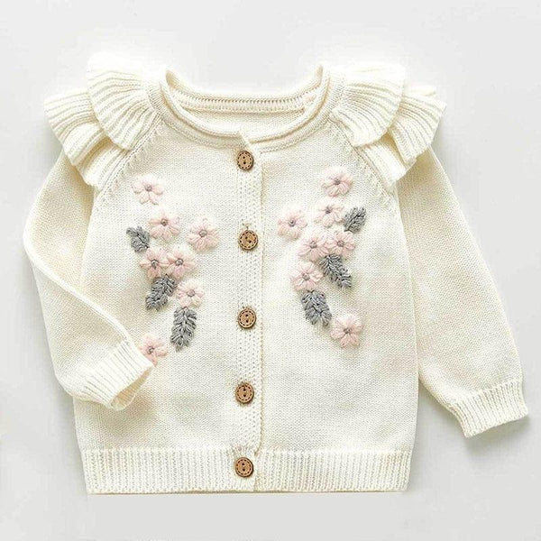 Cream crocheted floral baby romper set with pink and gray flower details and ruffled shoulders for infants