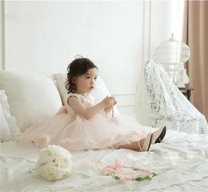 Baby girl tulle dress with bow in light pink, toddler size, sleeveless with gold trim detail