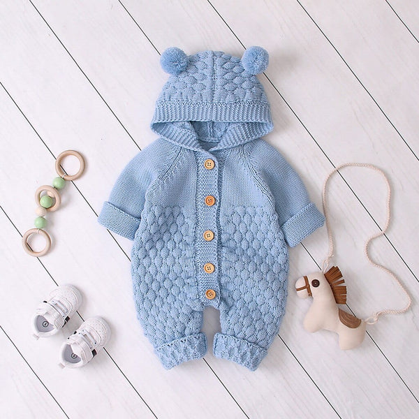 Baby blue hooded knitted romper for babies with pom pom ears and wooden buttons, suitable for infants