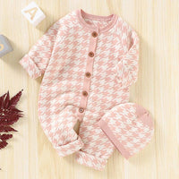Pink and white houndstooth baby romper set with long sleeves and matching hat for infants