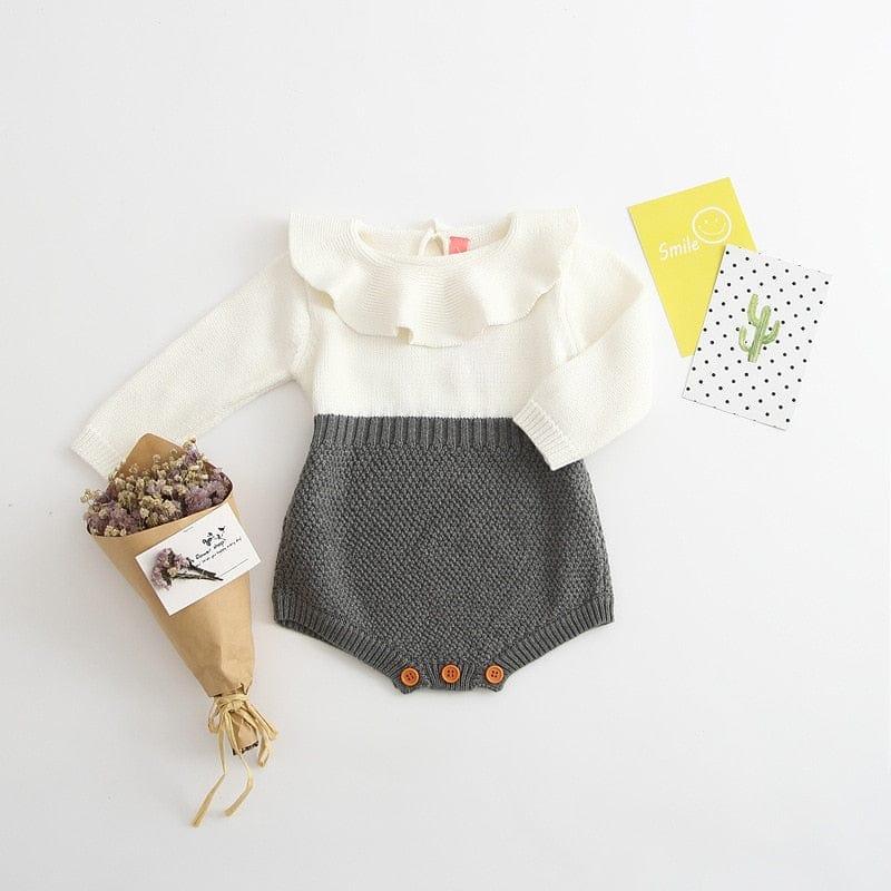 White and gray knit romper for babies with long sleeves and wooden button details