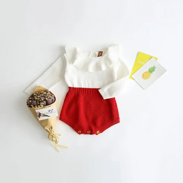 white and red knit romper for babies with long sleeves and button details for infants
