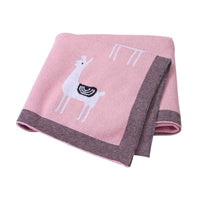 Pink soft knitted baby blanket for infants with white llama design and striped edges