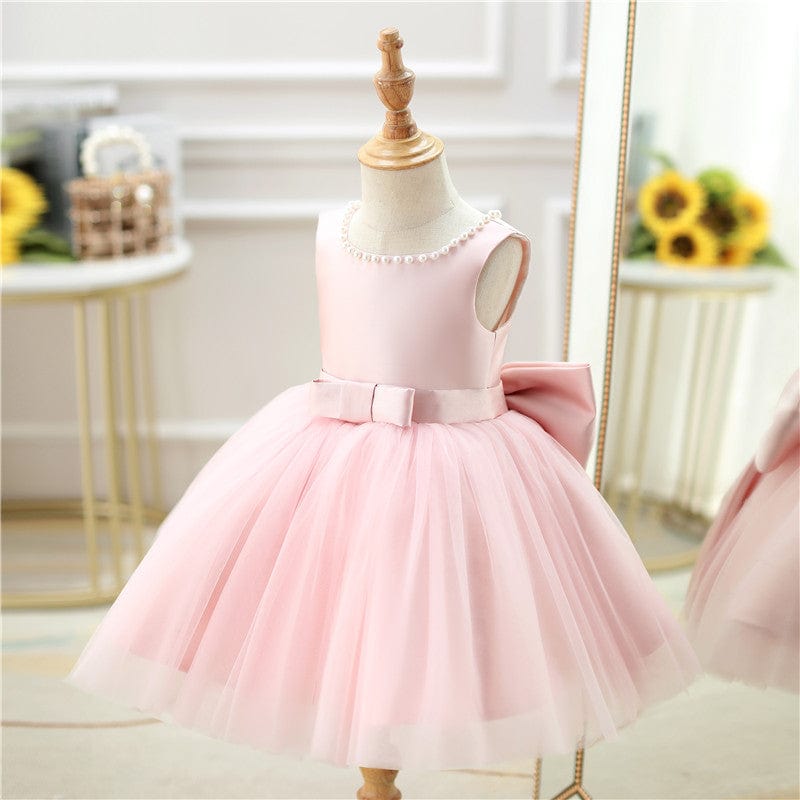 Pink baby girl special occasion dress with pearl neckline and large bow for toddlers