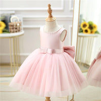 Pink baby girl special occasion dress with pearl neckline and large bow for toddlers