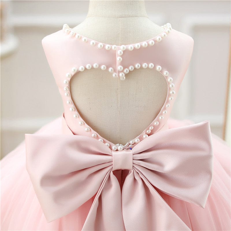 Pink baby girl special occasion dress with pearl heart cutout back and large satin bow