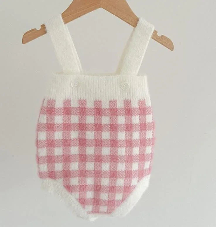 pink knitted romper and sweater set for babies with white and pink checkered pattern and straps