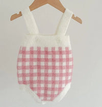 pink knitted romper and sweater set for babies with white and pink checkered pattern and straps