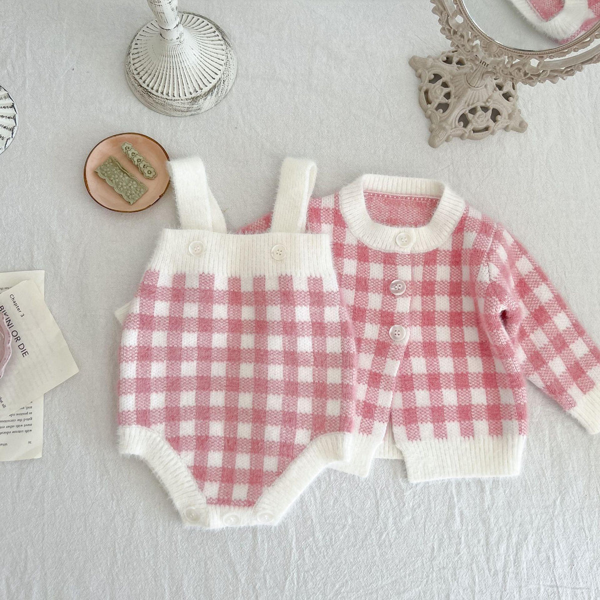 pink knitted romper and sweater set for babies with checkered pattern and long sleeves