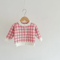 pink knitted romper and sweater set for babies with checkered pattern and button closure